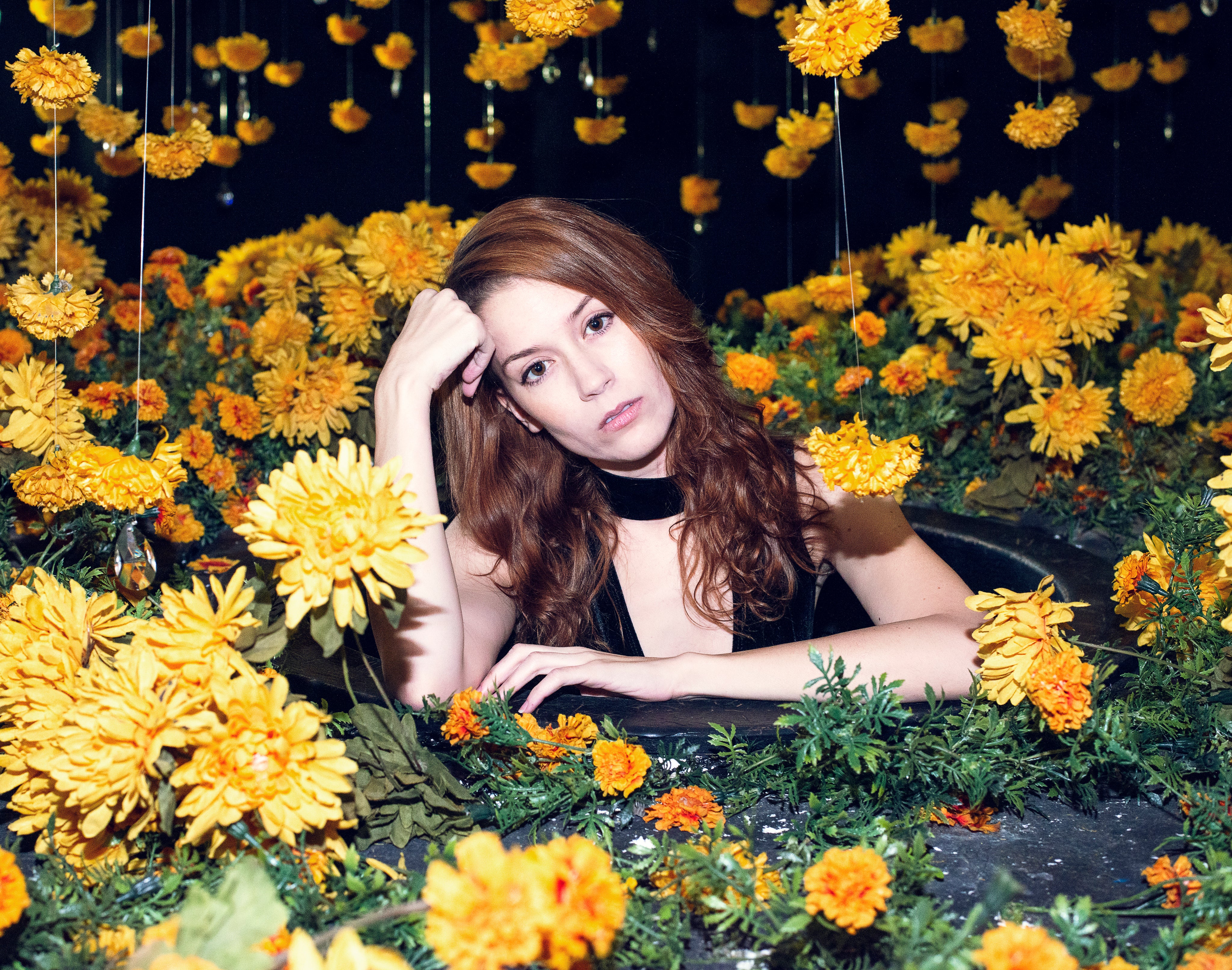files/woman-posing-in-center-of-yellow-floral-display.jpg